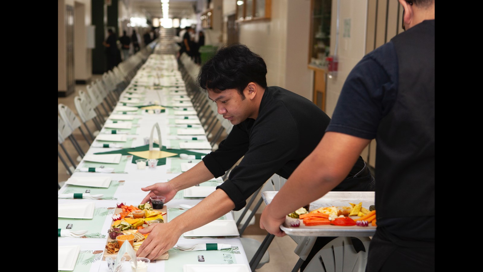 Student lays out a charcuterie board prior to the big meal.